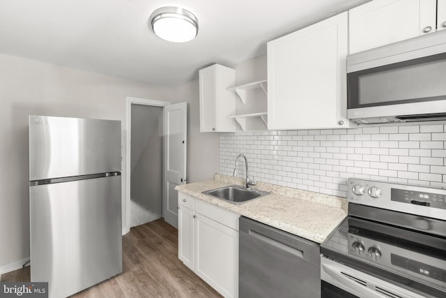96 Budd Ave, Pemberton, NJ 08068 - kitchen featuring open shelves, white cabinets, wood finished floors, a sink, and stainless steel appliances