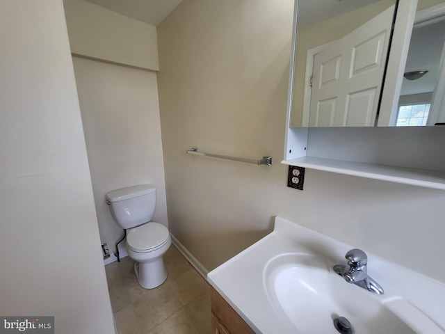 half bathroom featuring tile patterned flooring, toilet, and vanity