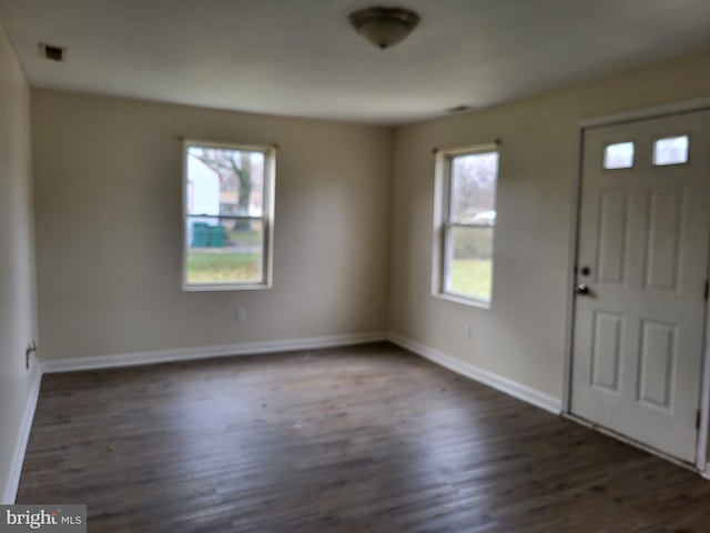 entryway featuring dark wood-type flooring, visible vents, and baseboards
