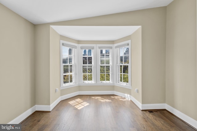 spare room featuring wood finished floors and baseboards