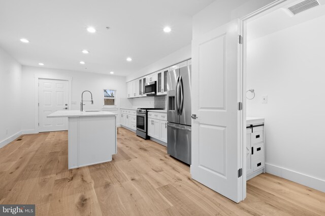 2049 E Letterly St, Philadelphia, PA 19125 - kitchen featuring white cabinetry, visible vents, a sink, stainless steel appliances, and a center island with sink