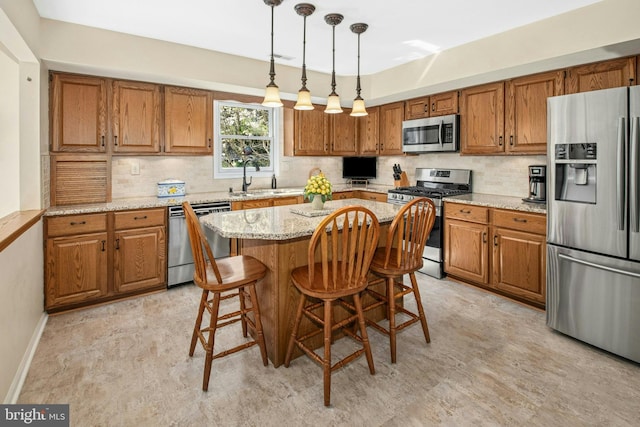 kitchen with brown cabinets, stainless steel appliances, a sink, and backsplash
