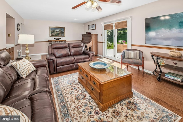 living area featuring a ceiling fan and wood finished floors