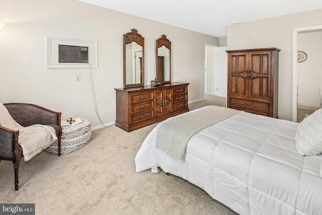 bedroom with baseboards, a wall unit AC, and carpet flooring
