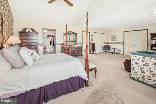 carpeted bedroom featuring a ceiling fan, a spacious closet, lofted ceiling, and a closet