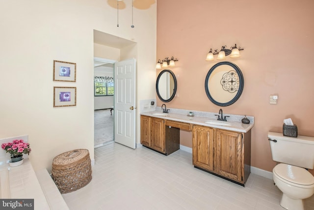 full bath with a sink, tile patterned flooring, and toilet