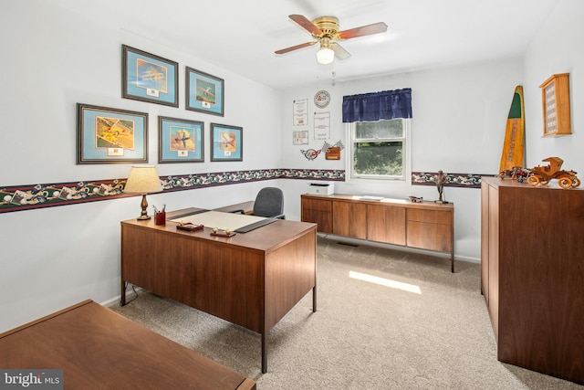 office area with light colored carpet, baseboards, and ceiling fan