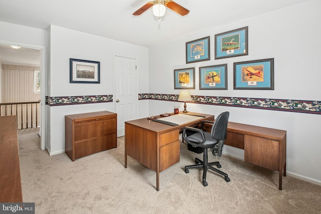 office featuring ceiling fan, light colored carpet, and baseboards