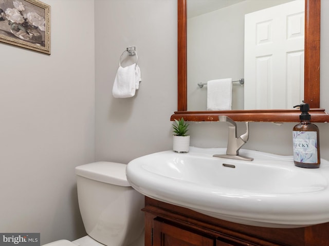 bathroom with toilet and vanity