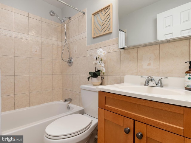 bathroom with toilet, tile walls, tub / shower combination, and vanity