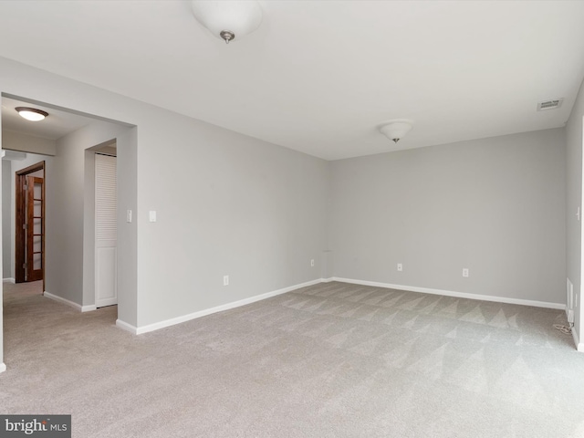 unfurnished room with visible vents, carpet flooring, and baseboards