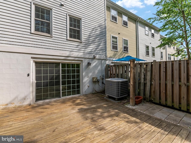 wooden deck featuring fence and central AC unit