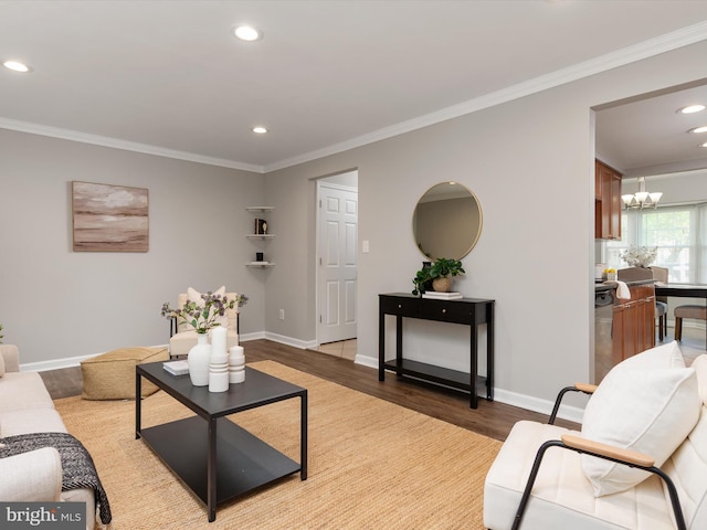 living room featuring ornamental molding, light wood finished floors, and a notable chandelier