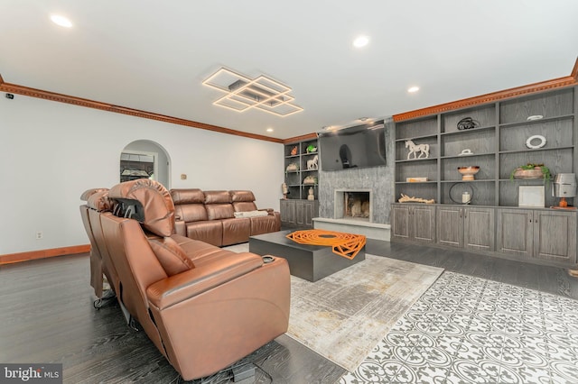 living area with ornamental molding, baseboards, recessed lighting, dark wood finished floors, and a high end fireplace