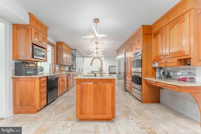 kitchen with built in appliances, a warming drawer, a chandelier, and light stone counters