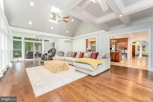 living room featuring ceiling fan, arched walkways, ornate columns, an AC wall unit, and recessed lighting