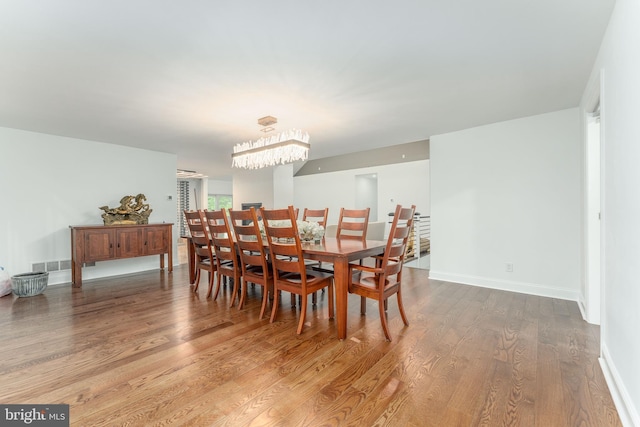 dining area featuring wood finished floors and baseboards