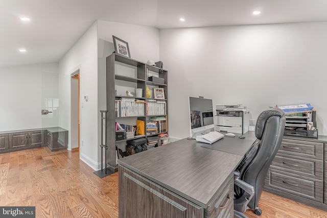 office with light wood-style flooring and recessed lighting