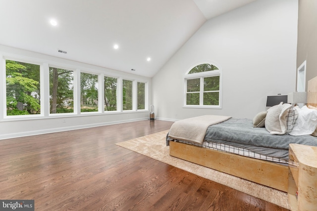 bedroom featuring wood finished floors, high vaulted ceiling, baseboards, and recessed lighting