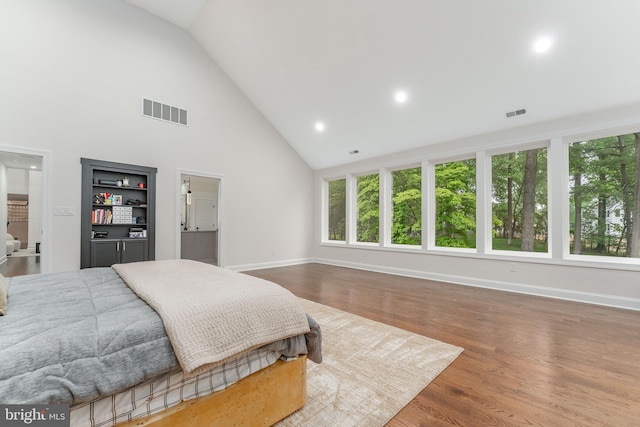 bedroom featuring high vaulted ceiling, baseboards, wood finished floors, and recessed lighting