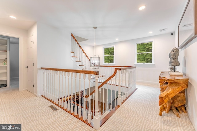 corridor with carpet floors, recessed lighting, an upstairs landing, and baseboards