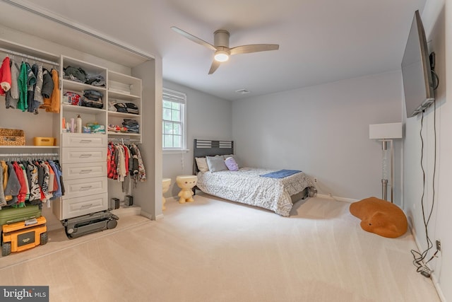 bedroom with carpet floors, a closet, baseboards, and a ceiling fan
