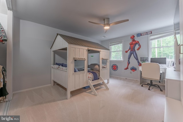 carpeted bedroom featuring baseboards, an office area, and ceiling fan