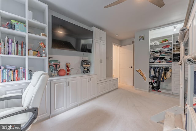 office area with a ceiling fan and light colored carpet