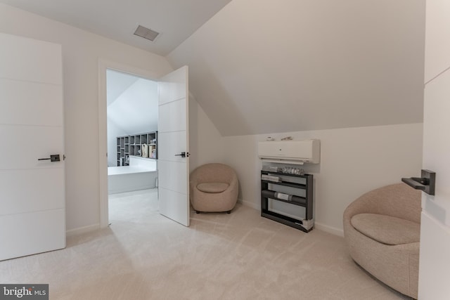 living area with light colored carpet, vaulted ceiling, and baseboards