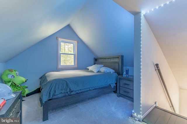 carpeted bedroom featuring lofted ceiling