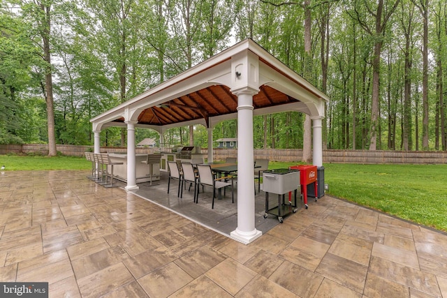 view of patio / terrace featuring a gazebo, area for grilling, and view of scattered trees