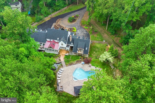 aerial view of property and surrounding area featuring a pool