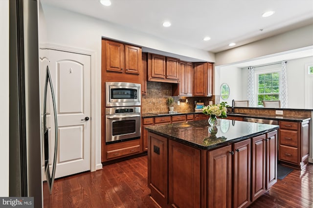 517 Deep Creek Vw, Annapolis, MD 21409 - kitchen featuring decorative backsplash, a sink, stainless steel appliances, a center island, and dark wood-type flooring