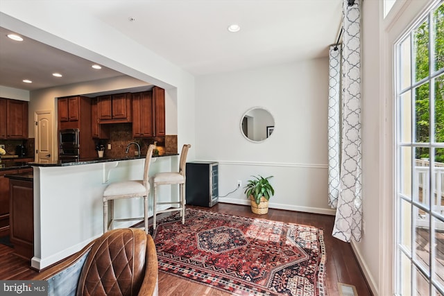 517 Deep Creek Vw, Annapolis, MD 21409 - kitchen featuring dark wood-style floors, tasteful backsplash, a healthy amount of sunlight, and stainless steel microwave