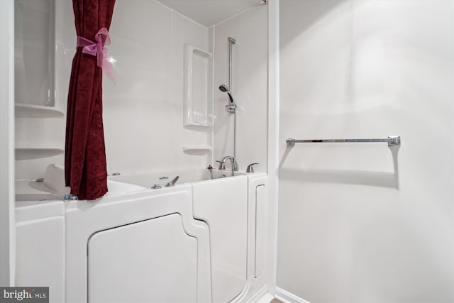 bathroom with a bath and a shower