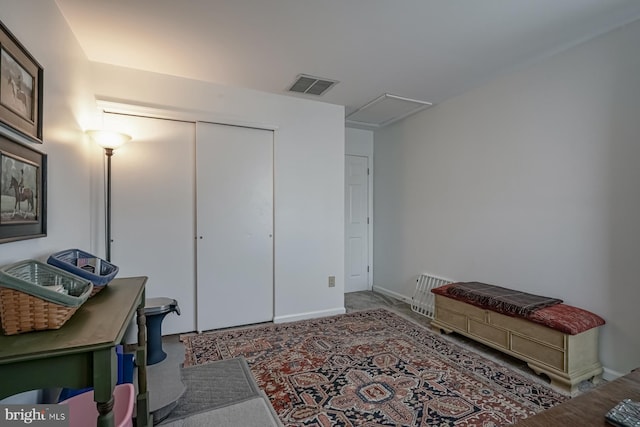 carpeted home office featuring attic access, visible vents, and baseboards