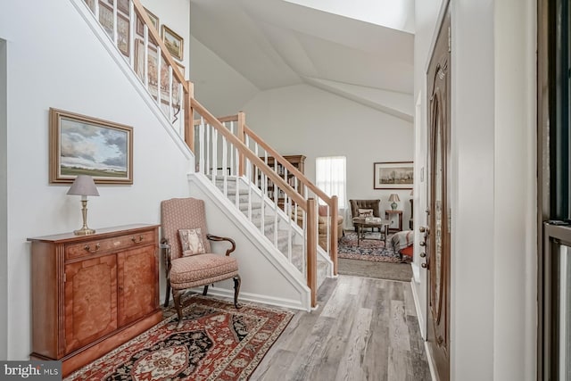 interior space with wood finished floors and vaulted ceiling