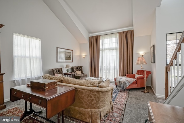 living room featuring baseboards, high vaulted ceiling, stairway, and carpet flooring