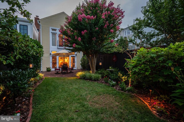 rear view of house featuring a yard and a patio