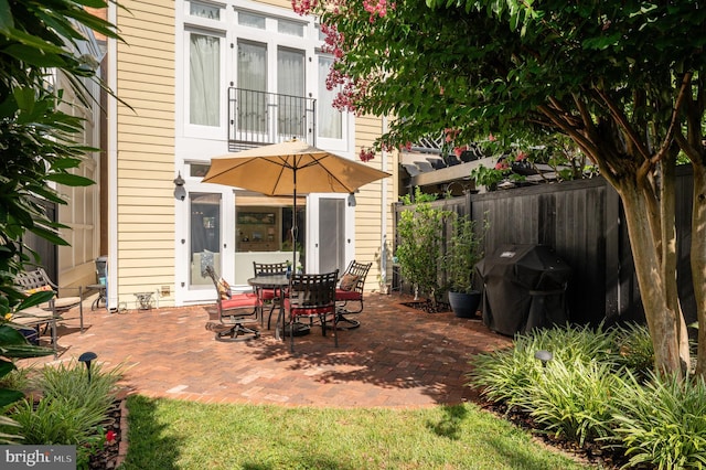 view of patio / terrace featuring fence and grilling area