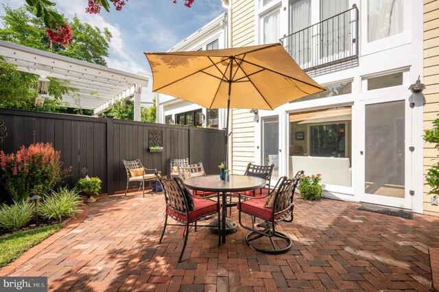 view of patio / terrace with fence, a pergola, and outdoor dining area