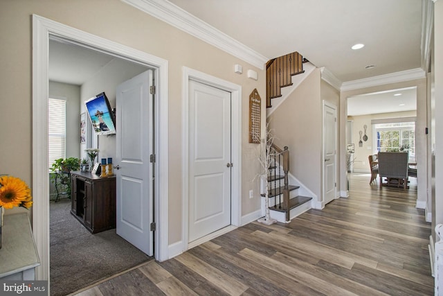 entrance foyer featuring crown molding, recessed lighting, baseboards, wood finished floors, and stairway