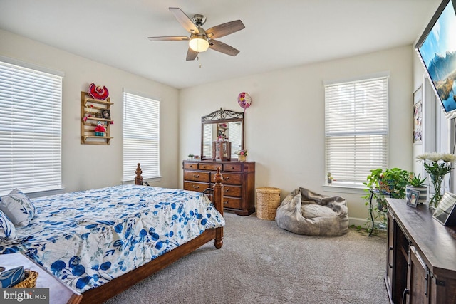carpeted bedroom featuring ceiling fan and baseboards