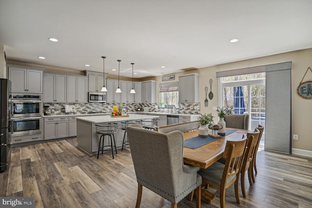 dining room with recessed lighting and dark wood finished floors
