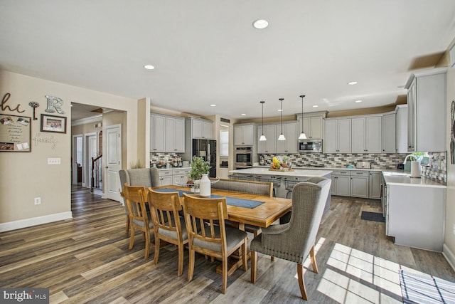 dining room featuring recessed lighting, baseboards, and dark wood-style flooring