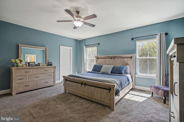 carpeted bedroom featuring baseboards and a ceiling fan