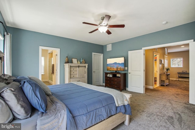 carpeted bedroom featuring visible vents, a ceiling fan, baseboards, and ensuite bathroom