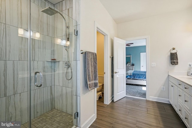bathroom with vanity, a shower stall, ensuite bath, and toilet