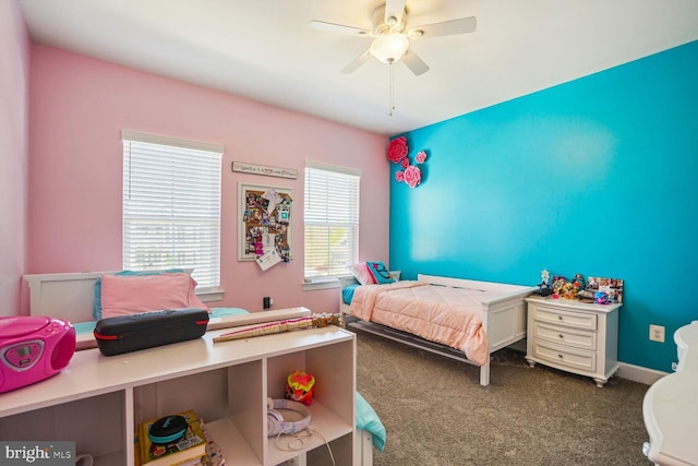 bedroom with a ceiling fan and dark colored carpet