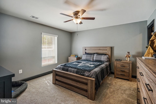 bedroom with a ceiling fan, baseboards, visible vents, and light carpet